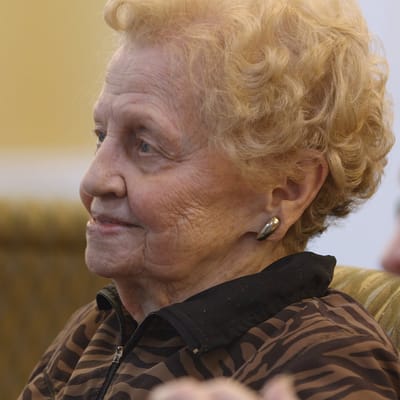 Close-up of a smiling senior woman in an activity space