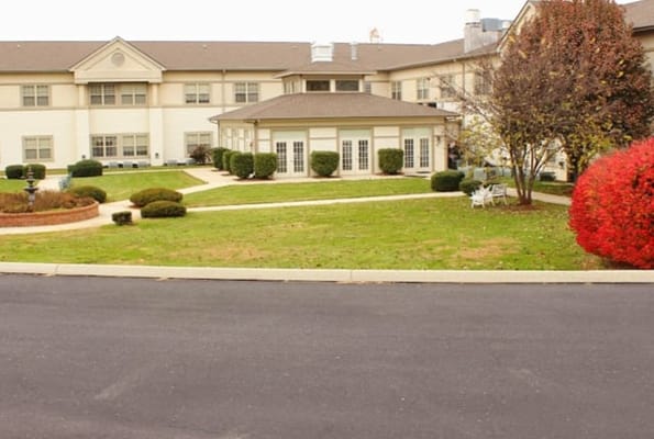 Exterior view of Cedar Hills Retirement Center with gardens
