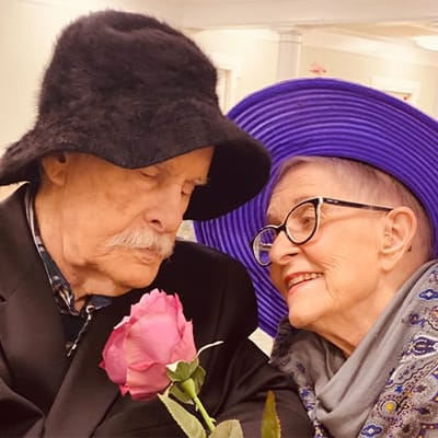 Couple enjoying a moment together with a rose indoors