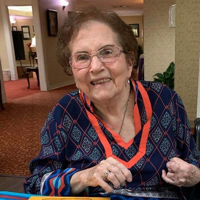 Smiling resident in a vibrant common area