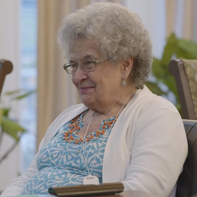 Senior resident smiling during an indoor activity