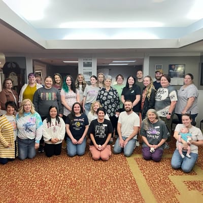 A group photo of staff and residents in a common area