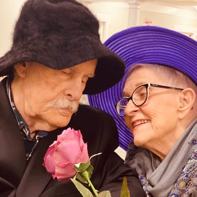 Residents sharing a joyful moment with a flower