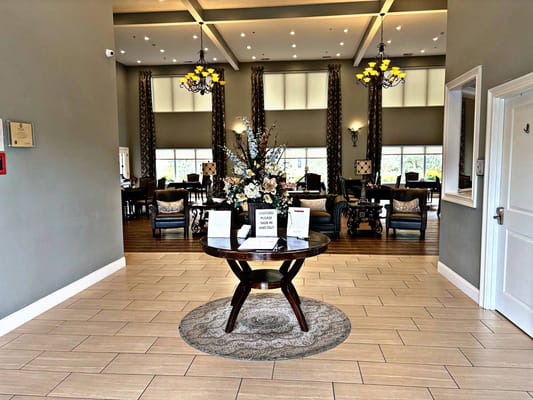 Elegant lobby area with seating and floral arrangement