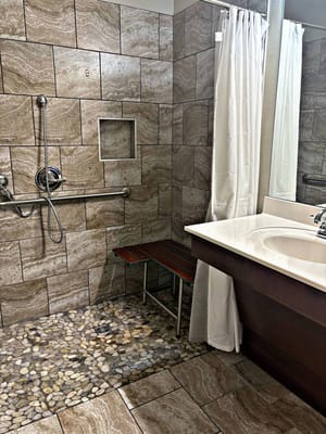 Accessible bathroom with grab bars and shower bench