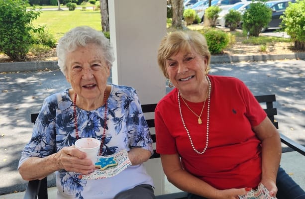 Two happy residents enjoying a sunny day outdoors