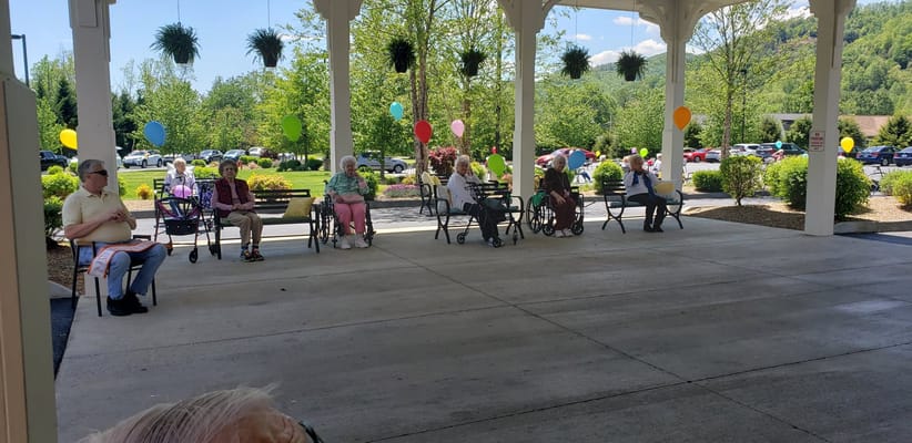 Residents enjoying an outdoor gathering with balloons