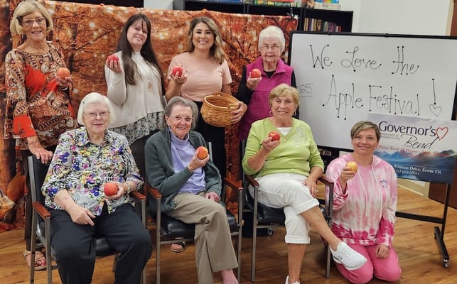 Residents celebrating the Apple Festival with smiles and apples