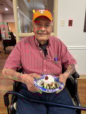 Resident enjoying dessert in a dining area