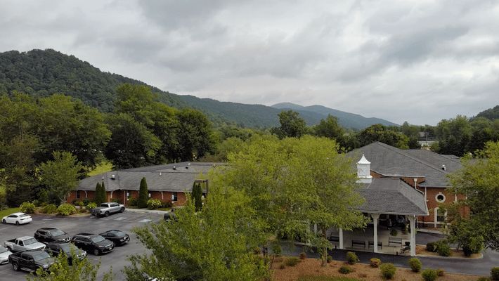Outdoor view of a senior living facility with mountains in the background