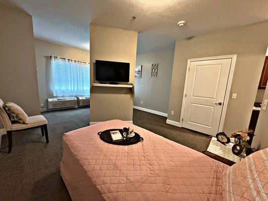 Cozy interior view of a resident room with a bed and TV