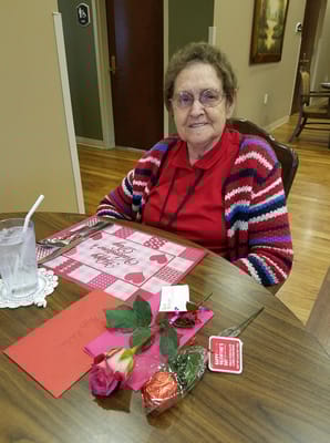 Resident seated at a table decorated for a celebration