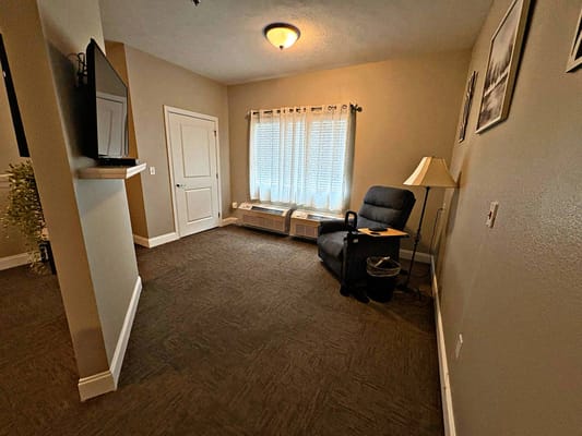 Cozy resident room with a chair and window