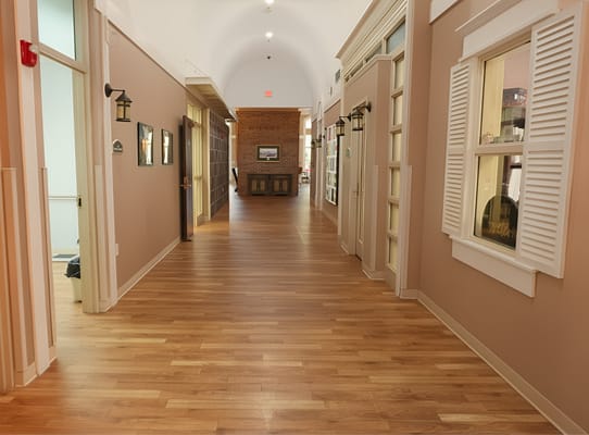 Hallway in a senior living facility with wooden flooring