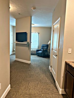 Interior view of a hallway with a chair and TV