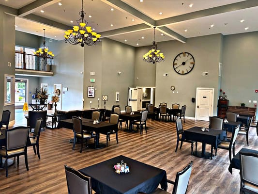Bright dining area with tables and chairs arranged