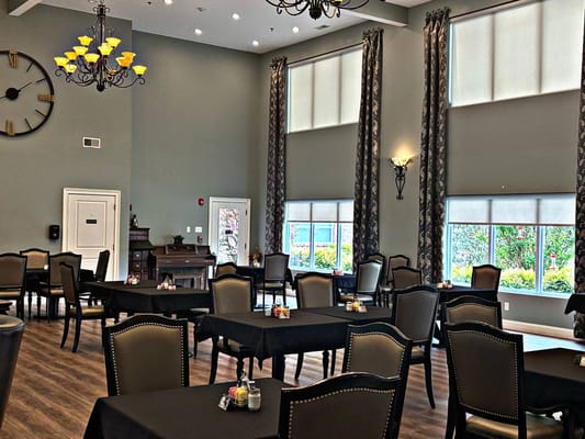 Elegant dining room with tables set for residents