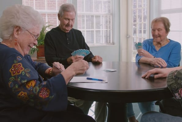Residents playing cards in a communal area