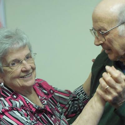 Residents enjoying a dance together in a common area