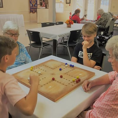 Residents playing a board game in a common area