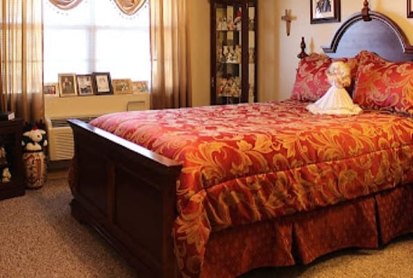 Cozy resident room with a decorated bed and personal items