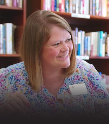 Staff member interacting with a resident in a library