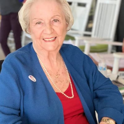 Senior resident smiling while seated indoors