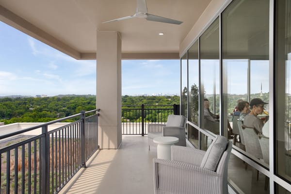 Residents enjoying a balcony view at The Crestmoor at Green Hills