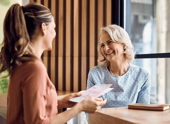 A senior resident enjoying a conversation with staff