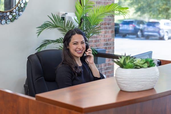 Reception area with a smiling staff member