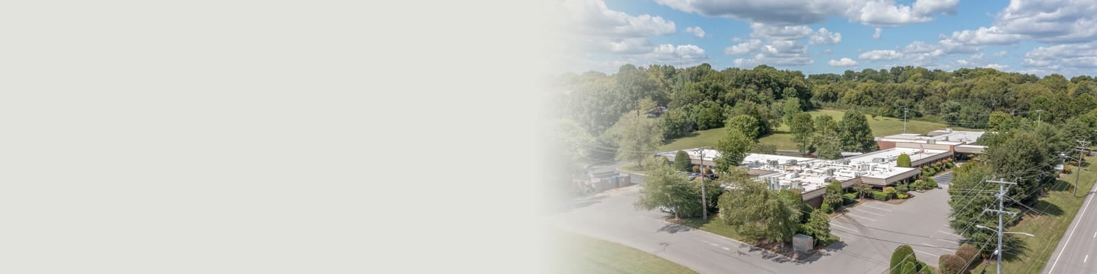 Aerial view of the facility surrounded by greenery