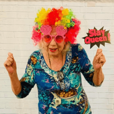 Resident celebrating with colorful attire and props