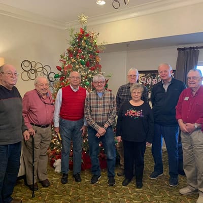 Residents posing together in a decorated common area