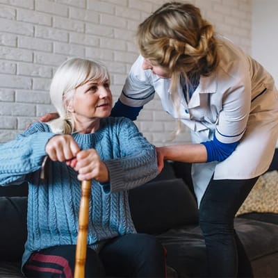 Caregiver assisting a resident in a cozy room