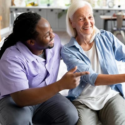 Staff member engaging with a resident in a facility