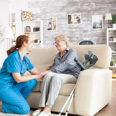 A caregiver interacting with a senior resident in a cozy living space