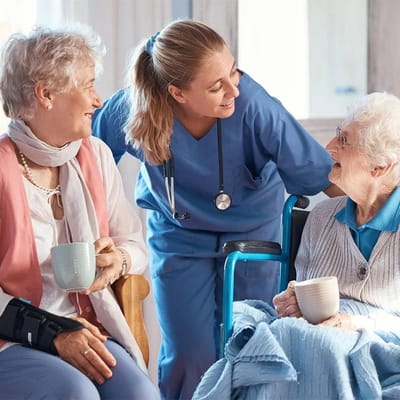 Caregiver interacting with residents in a warm setting