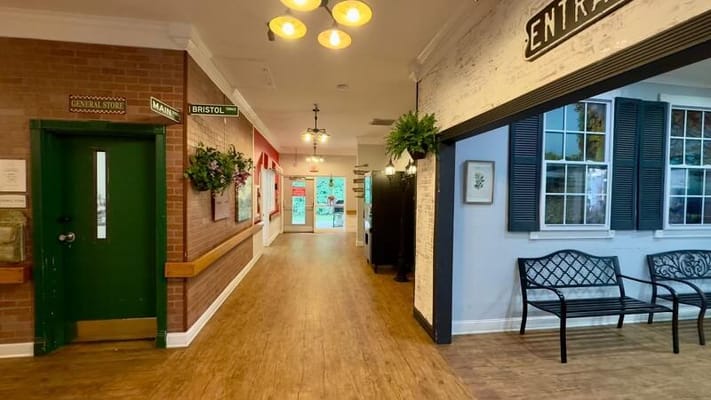 Bright interior hallway with seating and signage