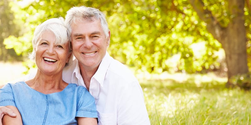 Happy senior couple outdoors in a garden