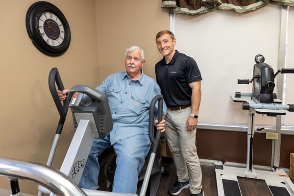 Resident engaged in physical therapy with staff member