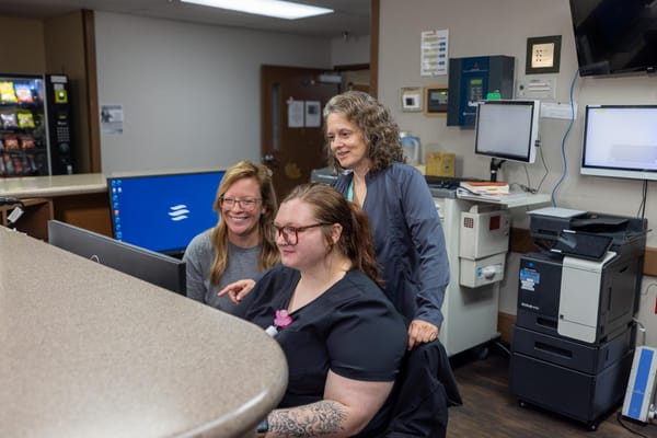 Staff assisting a resident at the reception area