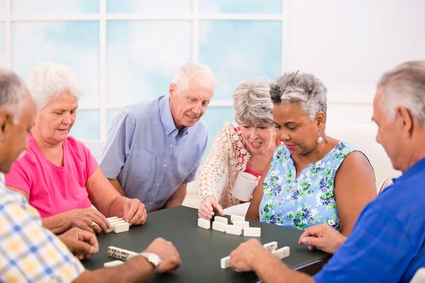 Residents playing dominoes in a common area