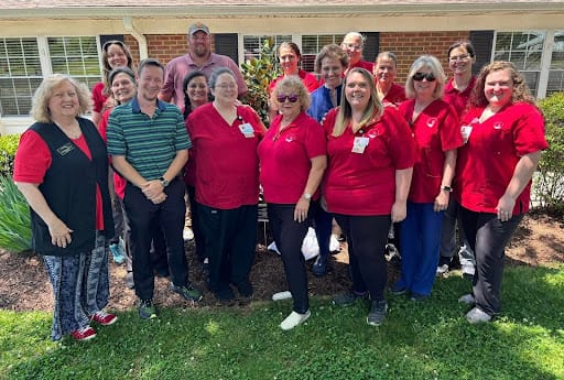 Staff photo in an outdoor area with flowers