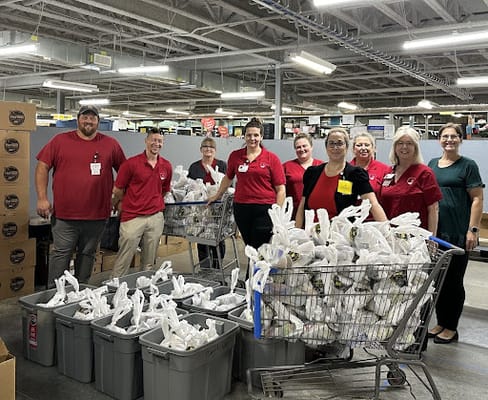 Staff members preparing food packages for residents