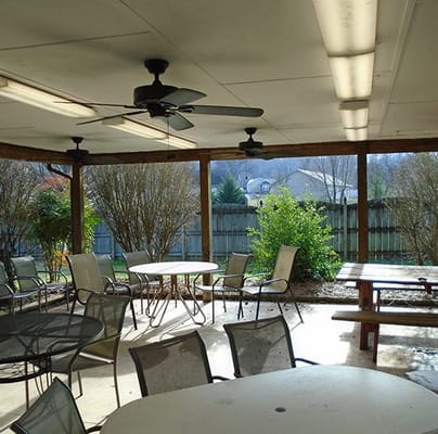 Covered outdoor seating area with tables and chairs