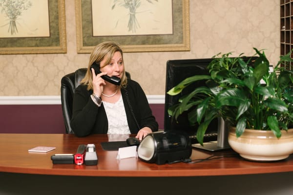 Receptionist answering phone at the front desk