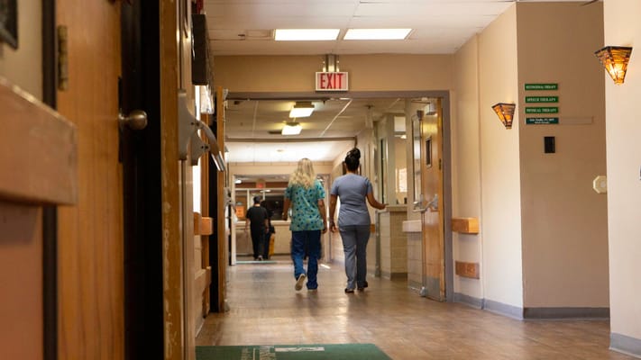 Staff members walking in a facility hallway