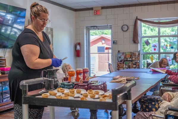 Staff preparing food items in a common area