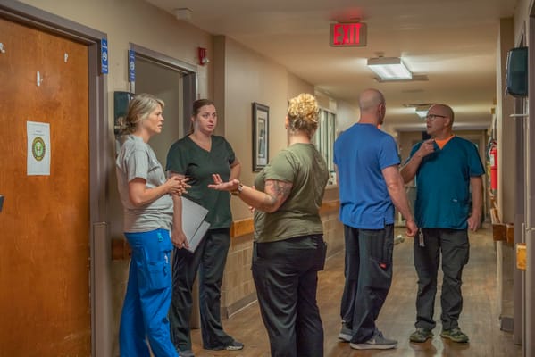 Staff members discussing in a hallway