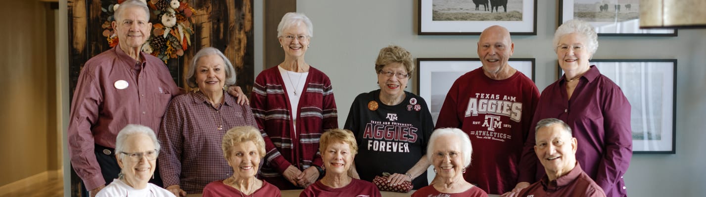 Group of residents in a common area smiling together